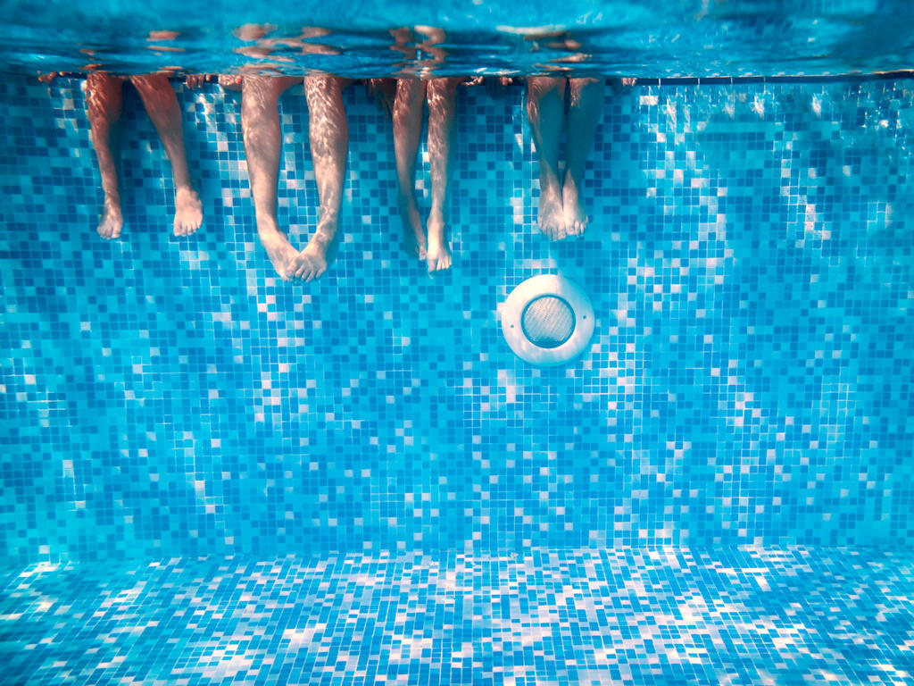 adults and childs legs in swimming pool water in mosaic pool, york hotels with a pool